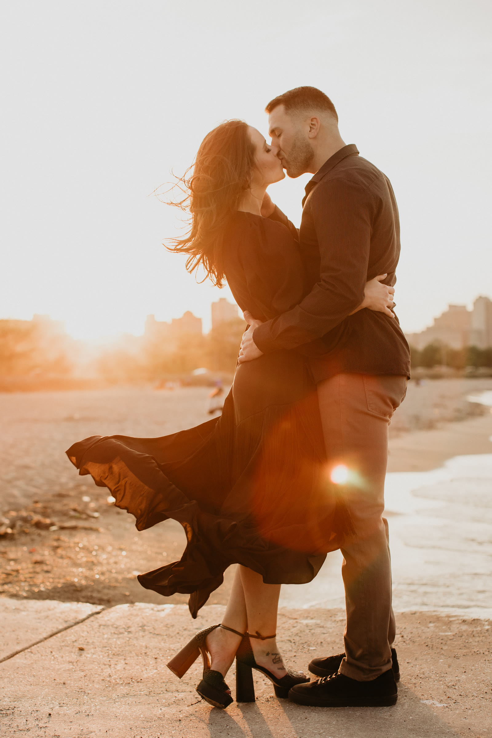 Couple kissing on a beach at sunset